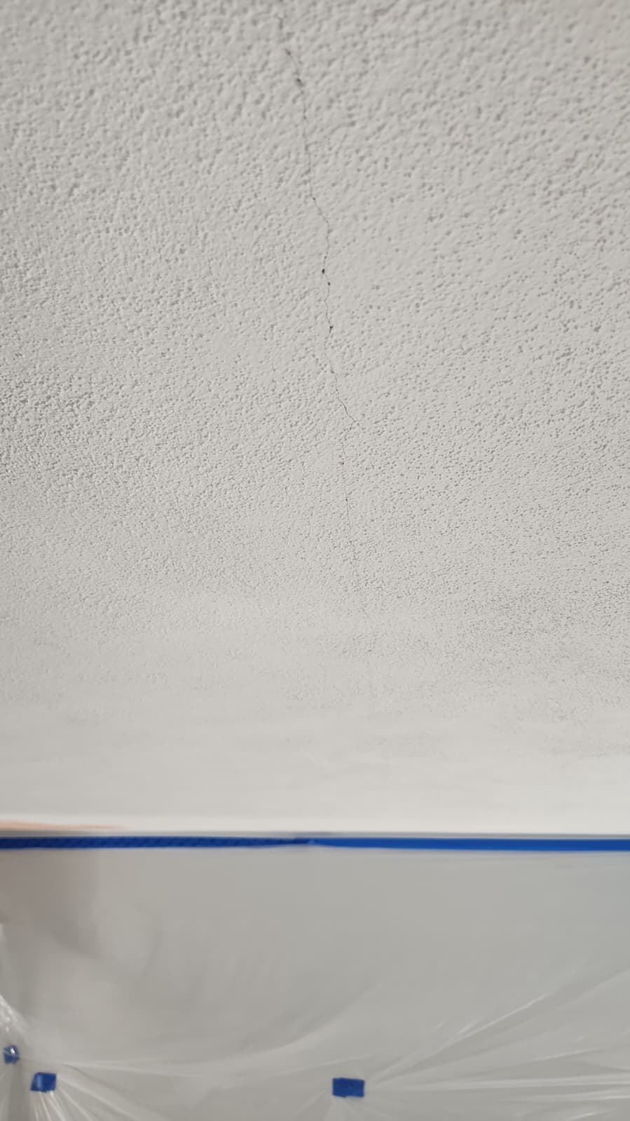 Crack in a textured ceiling before repair